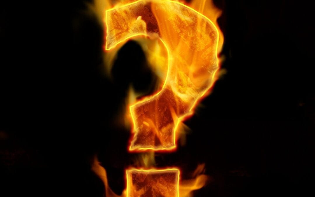 A large, bright orange question mark made of fire, glowing intensely against a dark black background.